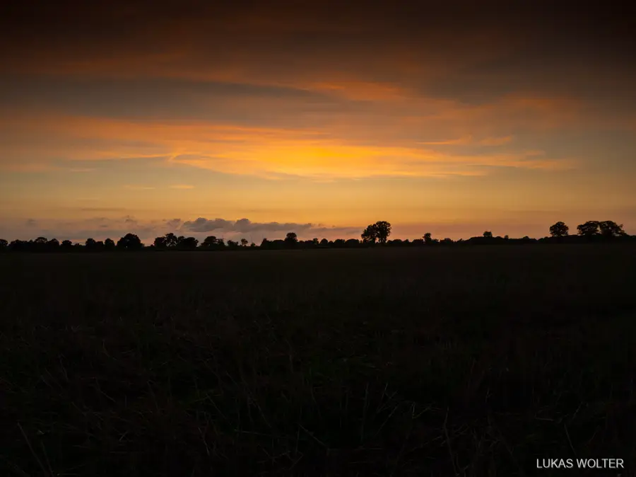Evening sky over a harvested field